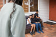© Austockphoto - First nations family sitting together on couch outside