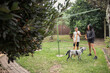 © Austockphoto - Aboriginal family playing instruments in backyard