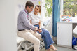 © Austockphoto - Male doctor holding a tablet  and talking to a female patient in the clinic