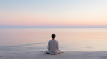 Individual Meditating At Sunrise On A Pristine Beach, Calm Sea, Pastel Sky With First Light Of Dawn, Minimalist Aesthetic