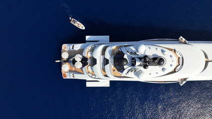 Aerial drone top down photo of latest technology mega yacht luxurious wooden stern anchored in deep blue sea