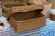 a wicker box lies on a colored fabric with an ornament