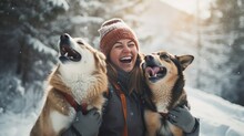 A Young Woman In Warm Clothes Walking Her 2 Dogs In A Picturesque Snowy Mountain Outdoor. Female Laughing And Playing With Pets And One Dog Licking An Owner's Cheek.Human And Pets Winter Concept Image