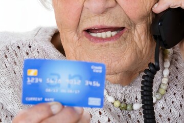 Senior Woman With Credit Card On Phone