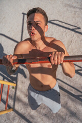 Wall Mural - Handsome male sports person doing push ups. Above view