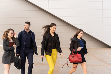 Wall Mural - Talking about their business plans and ideas while walking all together in front of the company and smiling