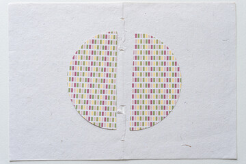 machine-cut semi-circular shapes cut from optically confusing patterned scrapbooking paper