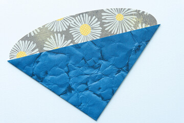 Wall Mural - paper shape object featuring two types of scrapbooking paper (blue and floral) on blank paper surface