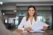 © insta_photos - Smiling mature business woman hr holding cv document at job interview. Happy mid aged professional banking manager or lawyer consulting client sitting at workplace in corporate office meeting.