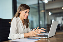 Happy Professional Mature Female Hr Manager, Smiling Mature Mid Aged Business Woman In Office Wearing Earbud Looking At Laptop Computer Having Hybrid Conference Work Meeting Or Remote Job Interview.