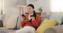 Happy Woman, Credit Card And Phone On Couch Online Shopping, Ecommerce And Fintech Easy Payment. Asian Person In China Typing Bank Information On Cellphone For Discount Or Finance Transaction At Home