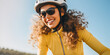© IndigoElf - Portrait of a happy smiling young woman dressed in cycling clothes, safety helmet and sunglasses riding a bicycle, closeup. Active sport horizontal banner.