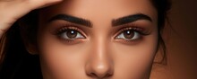 A Pretty Indian Woman Carefully Applies Her Favorite Eyeliner Tracing The Almond Shape Of Her Eyes With A Steady Hand Her Features Softened By The Warm Blush Of Makeup Spread Across