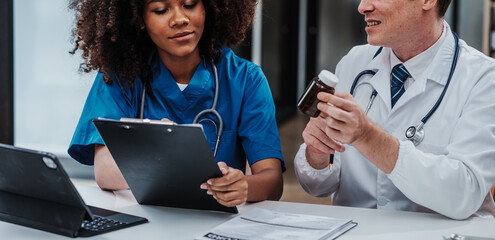 Wall Mural - Medical staff team african american meeting discussing chest x-ray film Radiologists medical doctors that specialize in diagnosing, treating injuries, diseases, radiology, procedures exams, tests