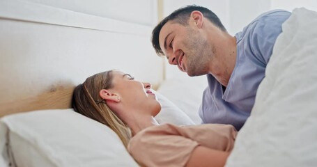 Wall Mural - Happy, relax and couple kissing in bed while in conversation for romance or bonding together. Smile, love and young man and woman with intimate moment for resting in bedroom at home in Australia.