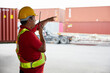 © offsuperphoto - senior worker talking on wireless radio in containers warehouse storage