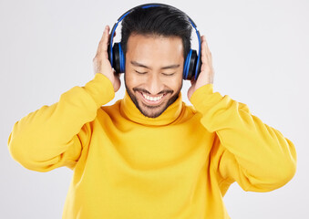 Poster - Man, headphones and listening with smile, studio and hearing with streaming subscription by white background. Young Mexican guy, student or fashion model with audio, music and sound with online radio