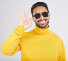 Poster - Fashion, happy and man with okay sign on a white background for approval, agreement and yes. Emoji, sunglasses and face of person smile in studio with perfect, good review and support hand gesture