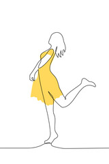 Wall Mural - slender woman in a yellow dress silhouette stands in full growth playfully raising her leg - one line art vector. the concept summer dress, female attractiveness, spring mood
