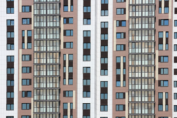 Windows of a multi-storey residential building. Abstract urban background.