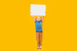 © somemeans - Full length portrait of girl of 4-5 years old with white empty board above her head. Child holds blank sheet of paper. Isolated on yellow background.
