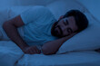 © Prostock-studio - Healthy Sleeping. Portrait of young indian man lying in bed in night