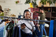 © Haas/peopleimages.com - Shopping, woman and phone call for fashion talk at a retail store with sale or discount. Black person or happy customer on a smartphone for product choice, promotion or communication in a boutique