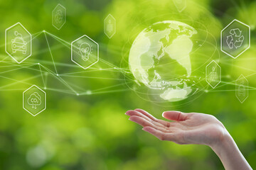 Environmental technology and Sustainable development goal (SDGs) concept. Hands holding Global communication network with Environment icon on a green background.