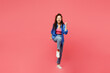 © ViDi Studio - Full body young woman of African American ethnicity wear blue shirt casual clothes doing winner gesture celebrate clenching fists say yes raise up leg isolated on plain pastel pink background studio.