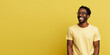© TimeaPeter - Attractive african american man wearing yellow tshirt and glasses. Isolated on yellow background.