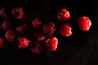 ripe red raspberries on a dark background