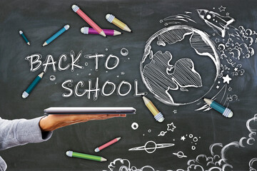 Poster - Close up of female hand holding tablet with abstract back to school sketch with pencils and rocket on chalkboard wall background. Education and knowledge concept.