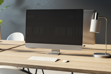 Poster - Close up of empty computer monitor on wooden office desktop with lamp and supplies. Designer workplace concept. Mock up, 3D Rendering.