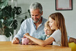 © Lumos sp - child money saving grandfather family coin senior grandchild bank piggybank  finance happy investment grandson granddaughter