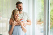 © gzorgz - Lovely mid aged couple standing at home by the window