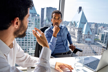 Wall Mural - Busy diverse workers team young people having discussion. Young professional African American executive sharing ideas with Latin colleague discussing marketing project strategy at meeting in office.