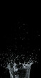 © slowmotiongli - Water spurting out against Black Background