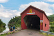© romylee - Tourists looking at the views at Wolfe point covered bridge at Fundy National park, Canada