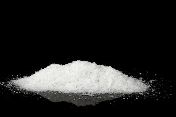 A pile of salt isolated on a black background.