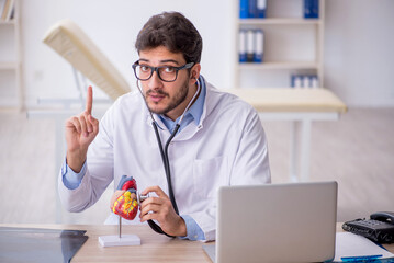 Sticker - Young male doctor cardiologist working in the clinic