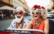 Senior couple have fun together and drive cabrio car around the city, unusual date concept
