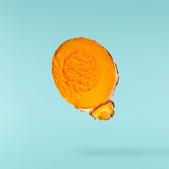 Fresh turmeric root falling in the air isolated