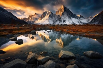 Wall Mural - a serene alpine mountain lake reflecting the surrounding high mountain peaks that are snow covered, 