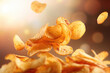 Flying potato chips up in the air in rays of the sun