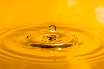 yellow drop oil , Liquid gold oil drop ripple background.