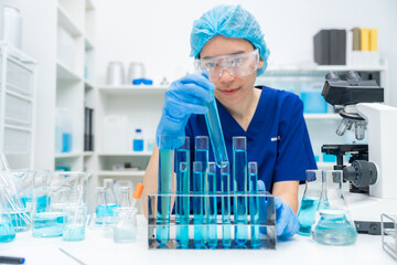 Wall Mural - laboratory glassware equipment for medicals science chemistry research, blue liquid in scientific gl