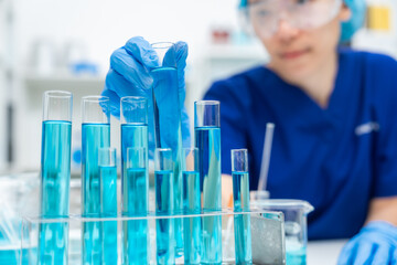 Wall Mural - laboratory glassware equipment for medicals science chemistry research, blue liquid in scientific gl