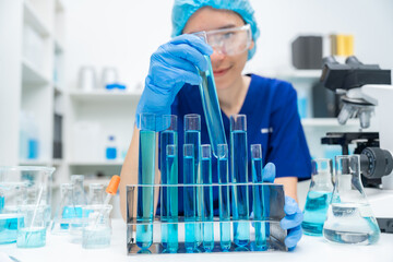 Wall Mural - laboratory glassware equipment for medicals science chemistry research, blue liquid in scientific gl