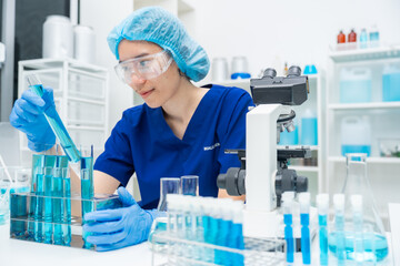 Wall Mural - laboratory glassware equipment for medicals science chemistry research, blue liquid in scientific gl