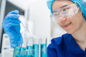 Wall Mural - laboratory glassware equipment for medicals science chemistry research, blue liquid in scientific gl